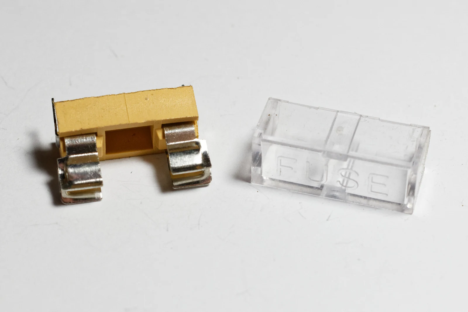 Black fuseholders with transparent lids for through-hole mounting; representative fuse-holder family image, not a BS88 exact-part photograph.